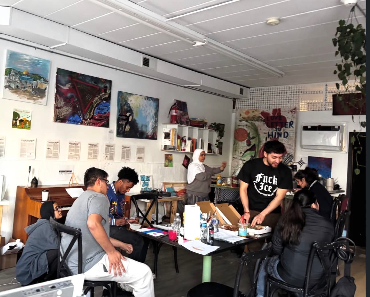 Community members making art together around a table in the studio